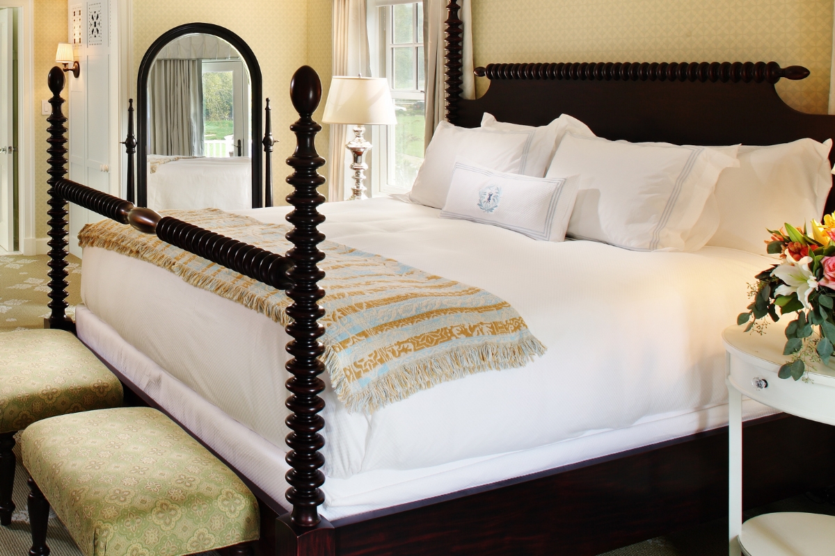 a bed with a mirror and a lamp