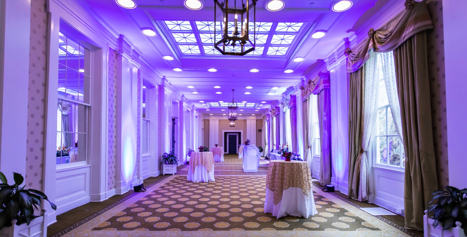 a room with tables and purple lights