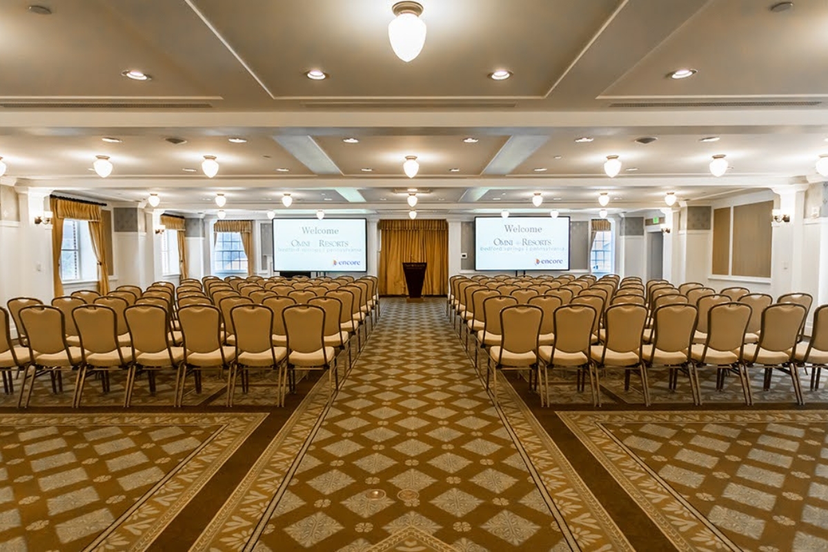a room with chairs and a screen