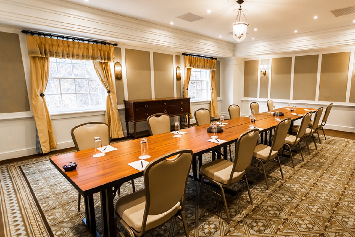 a room with a long table and chairs