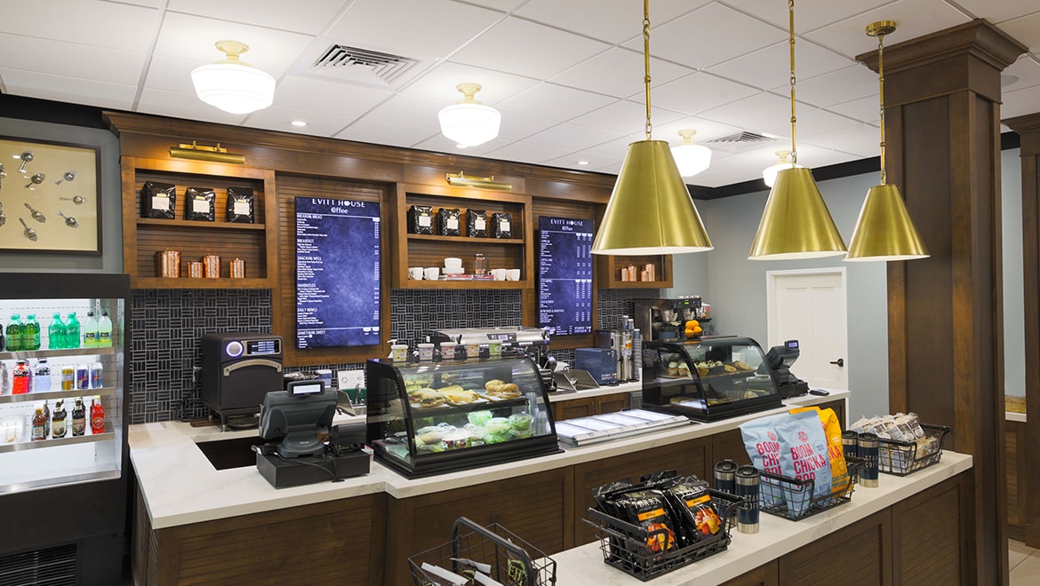 a coffee shop with a counter and shelves