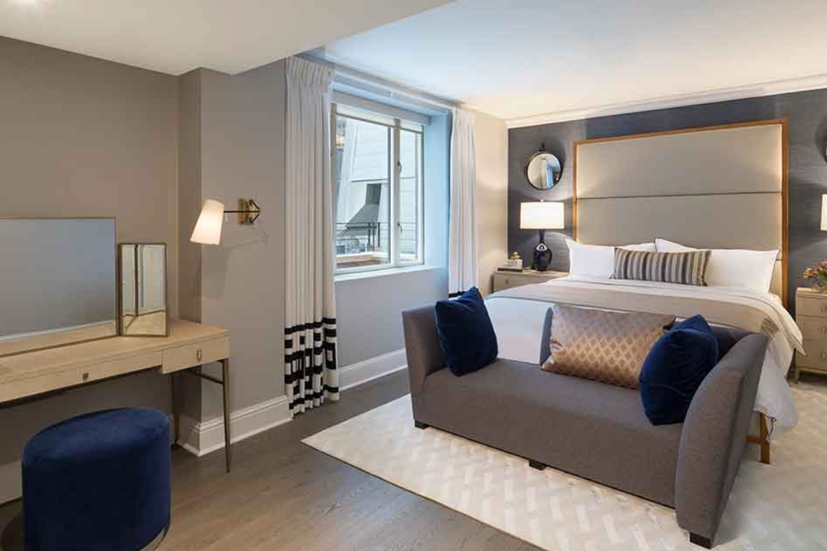 a bedroom with a bed and a mirror