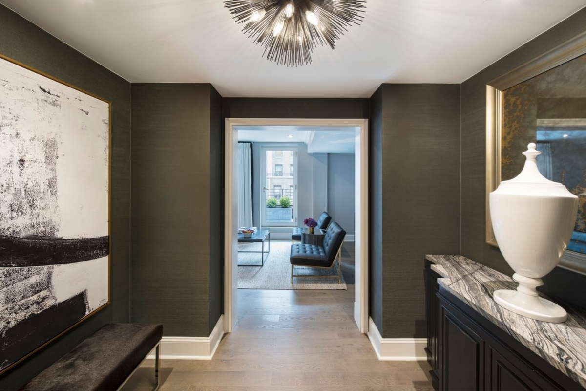 a hallway with a chandelier and a couch