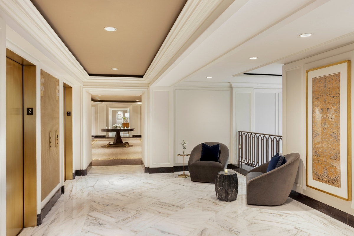 a hallway with chairs and a table