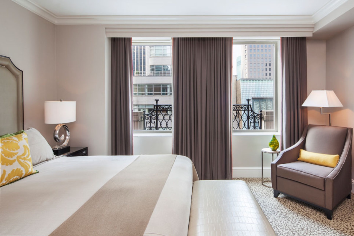 a bedroom with a bed and a chair