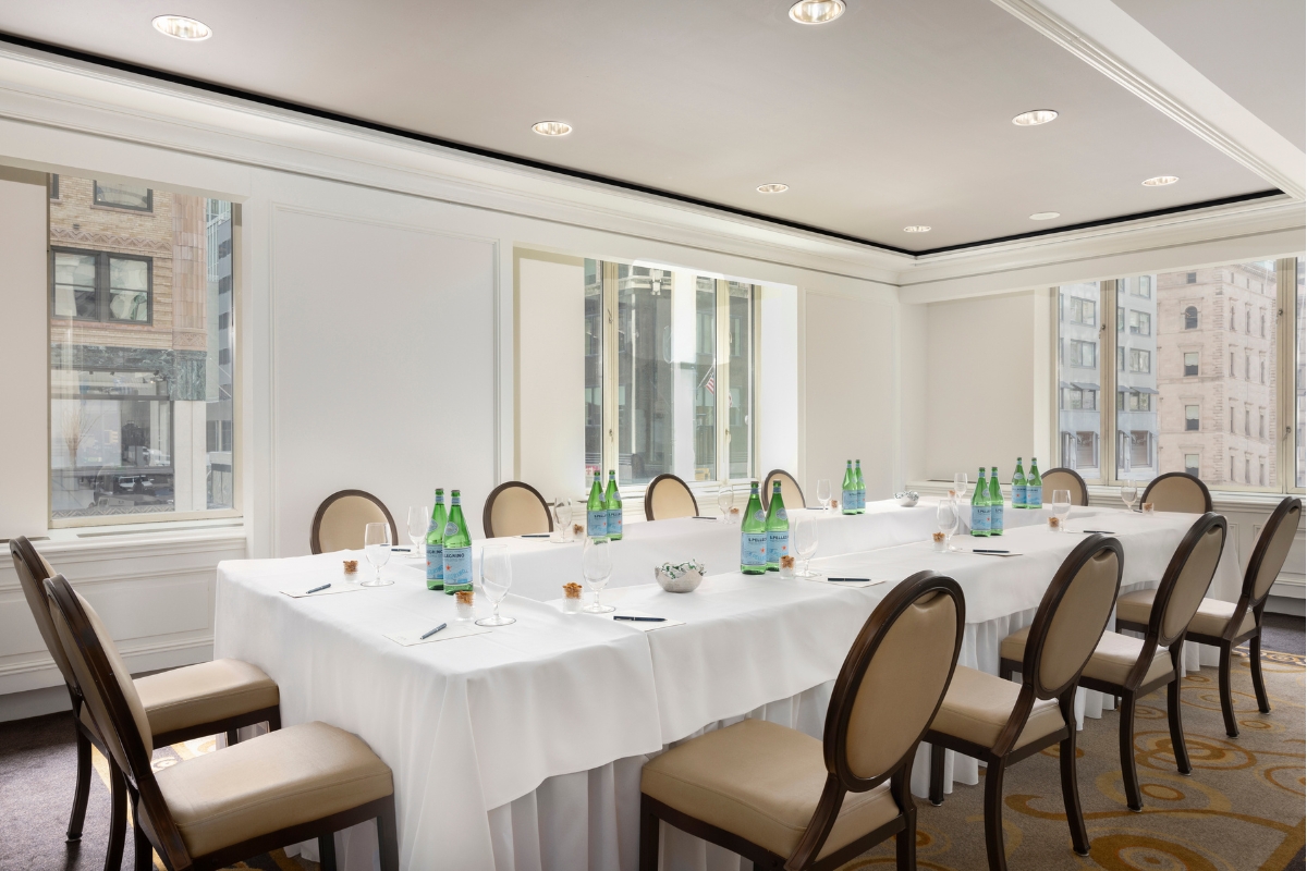 a table with white tablecloths and bottles of wine
