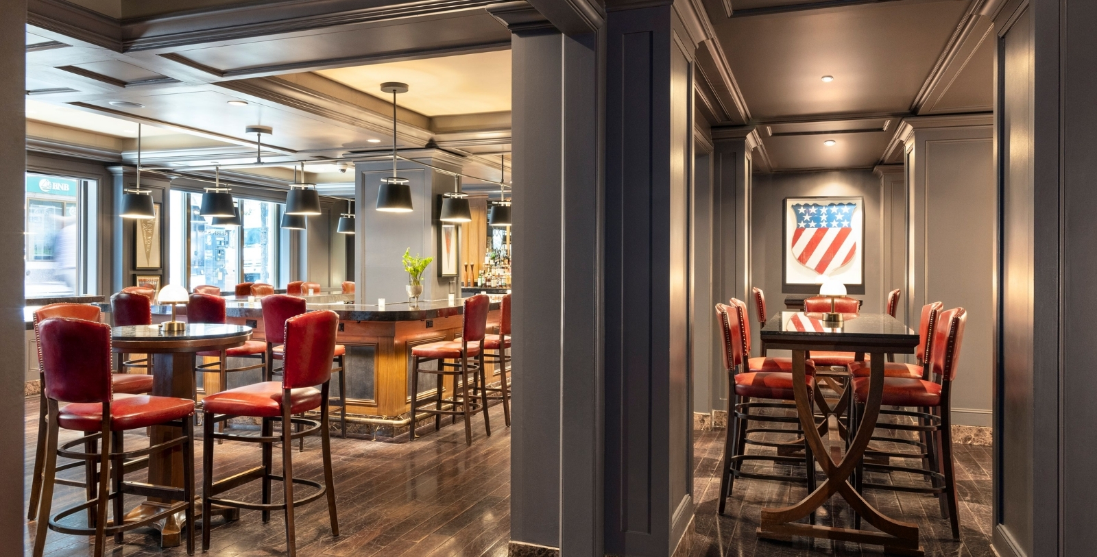 a room with a bar and chairs