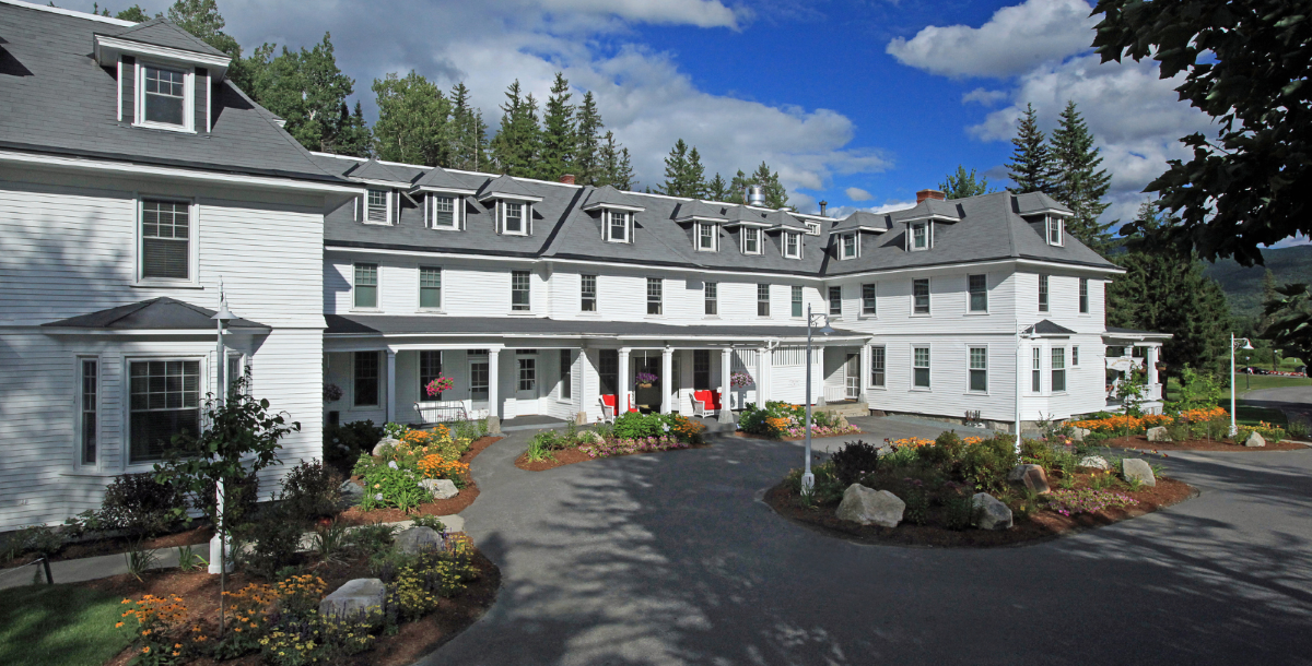 a large white building with a circular driveway
