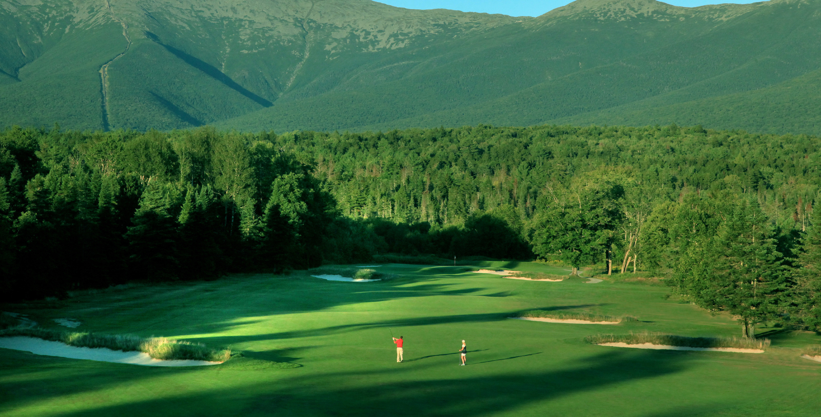 a couple of people on a golf course