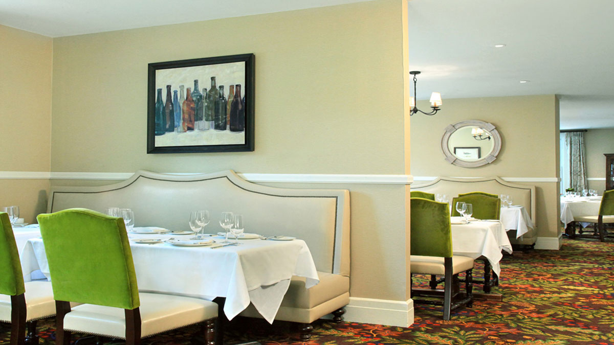 a restaurant booth seating with a couple of tables