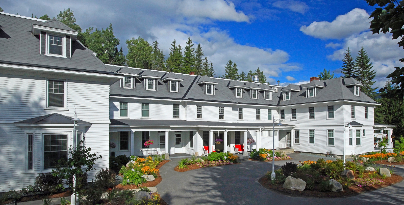 a large white building with a circular driveway