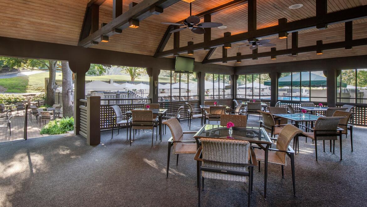 a patio area with tables and chairs