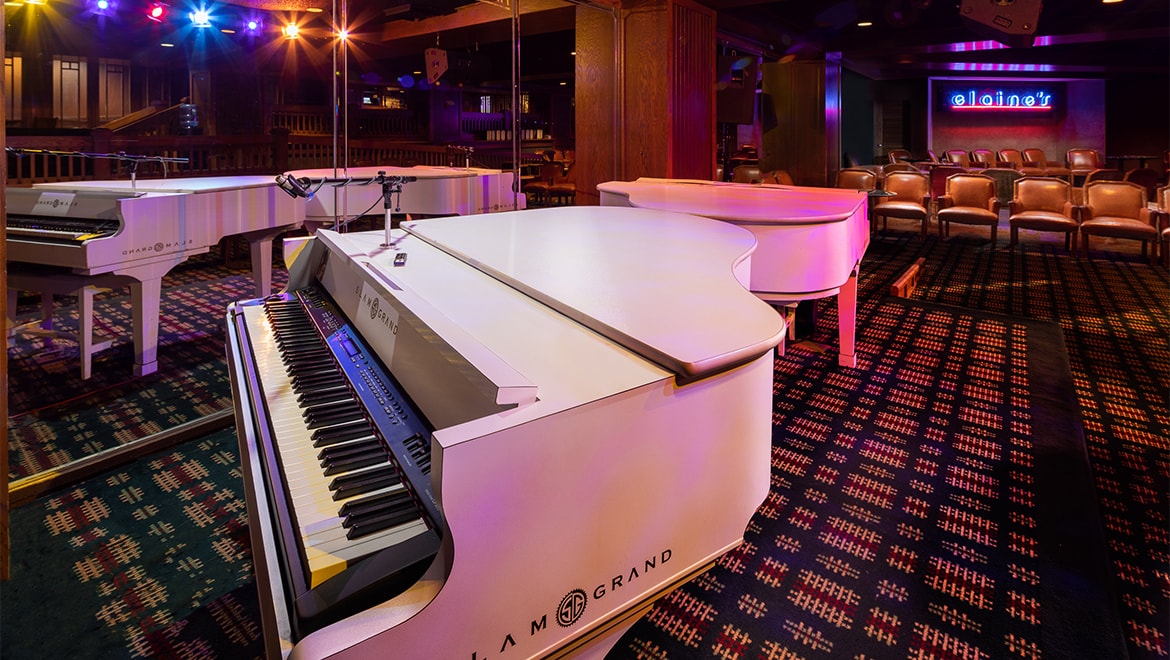 a group of white piano in a room