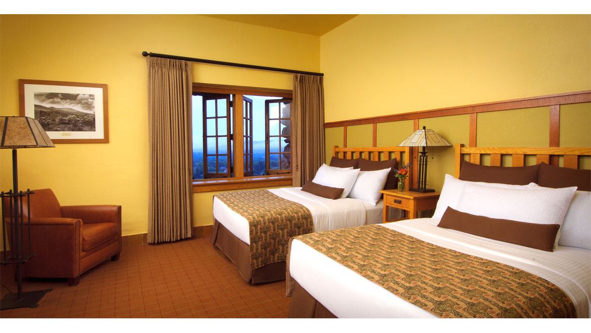 a room with two beds and a window