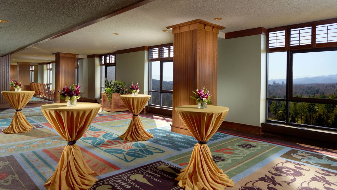 a room with tables and flowers