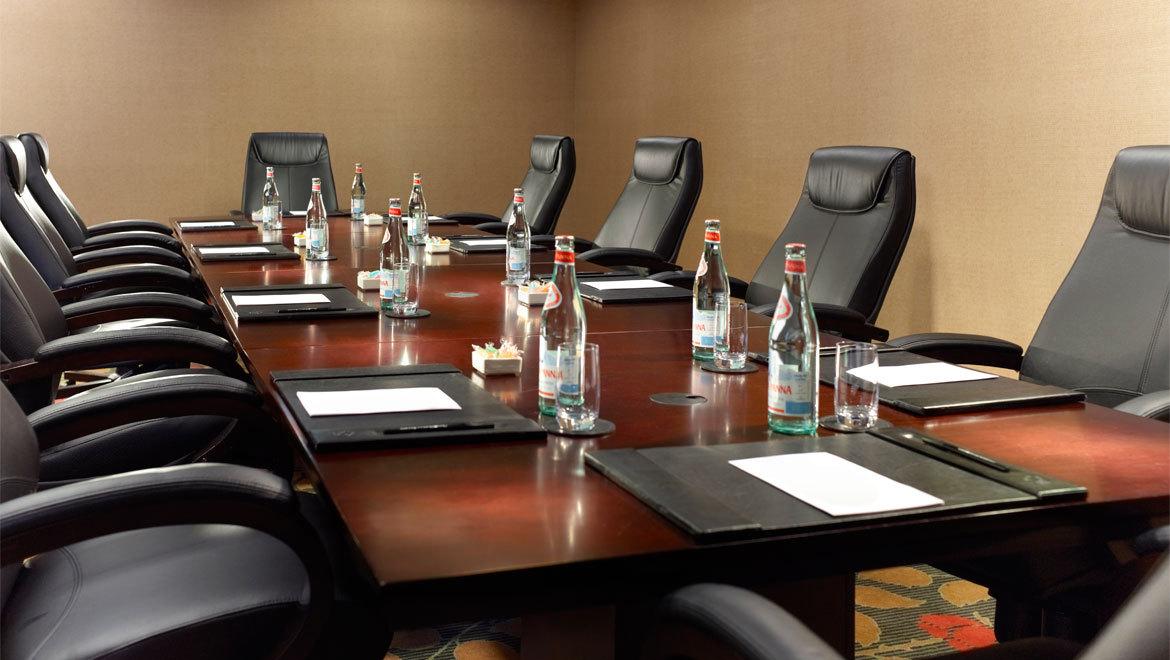 a conference room with chairs and a table with bottles of water