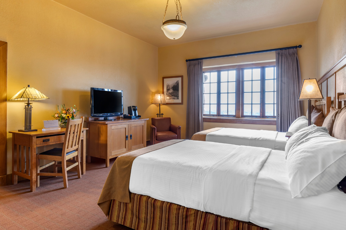 a room with two beds and a television