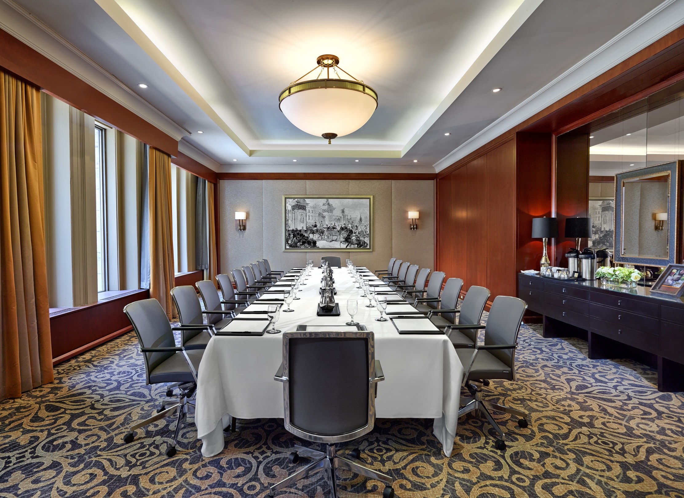 a room with a long table and chairs