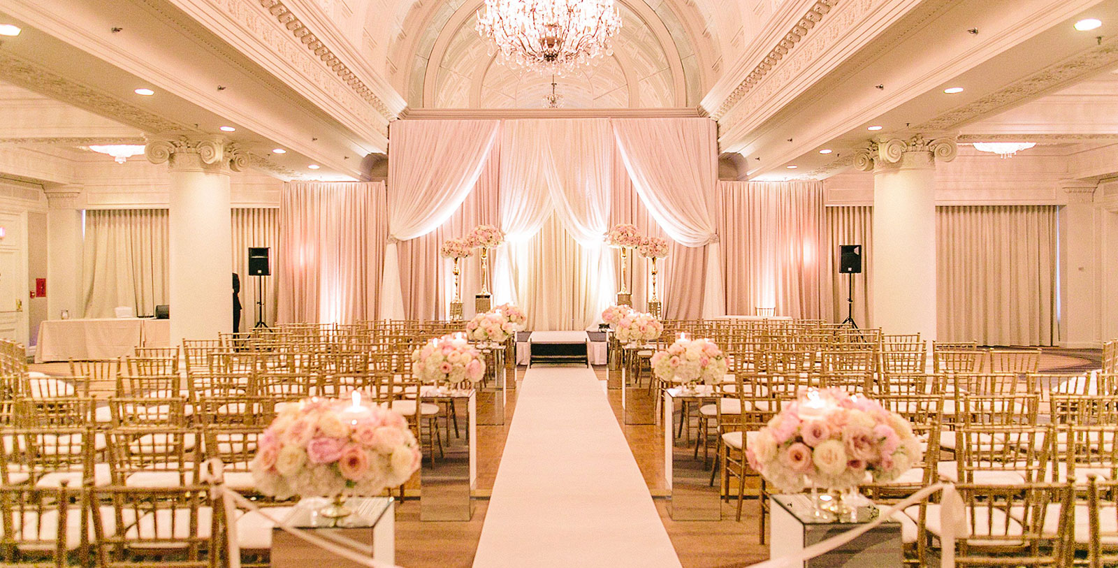 a wedding aisle with chairs and flowers