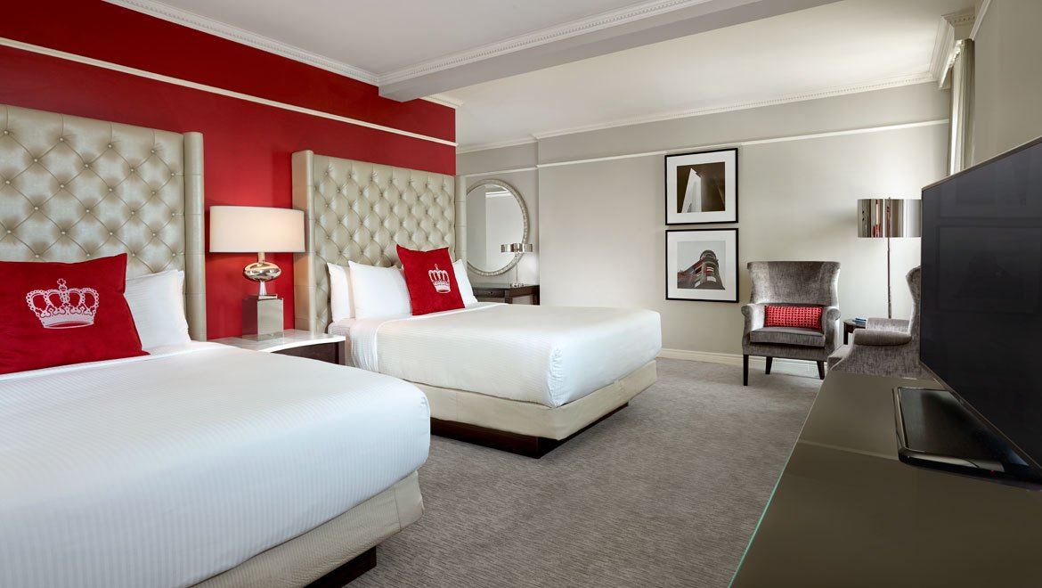 a room with two beds and a mirror