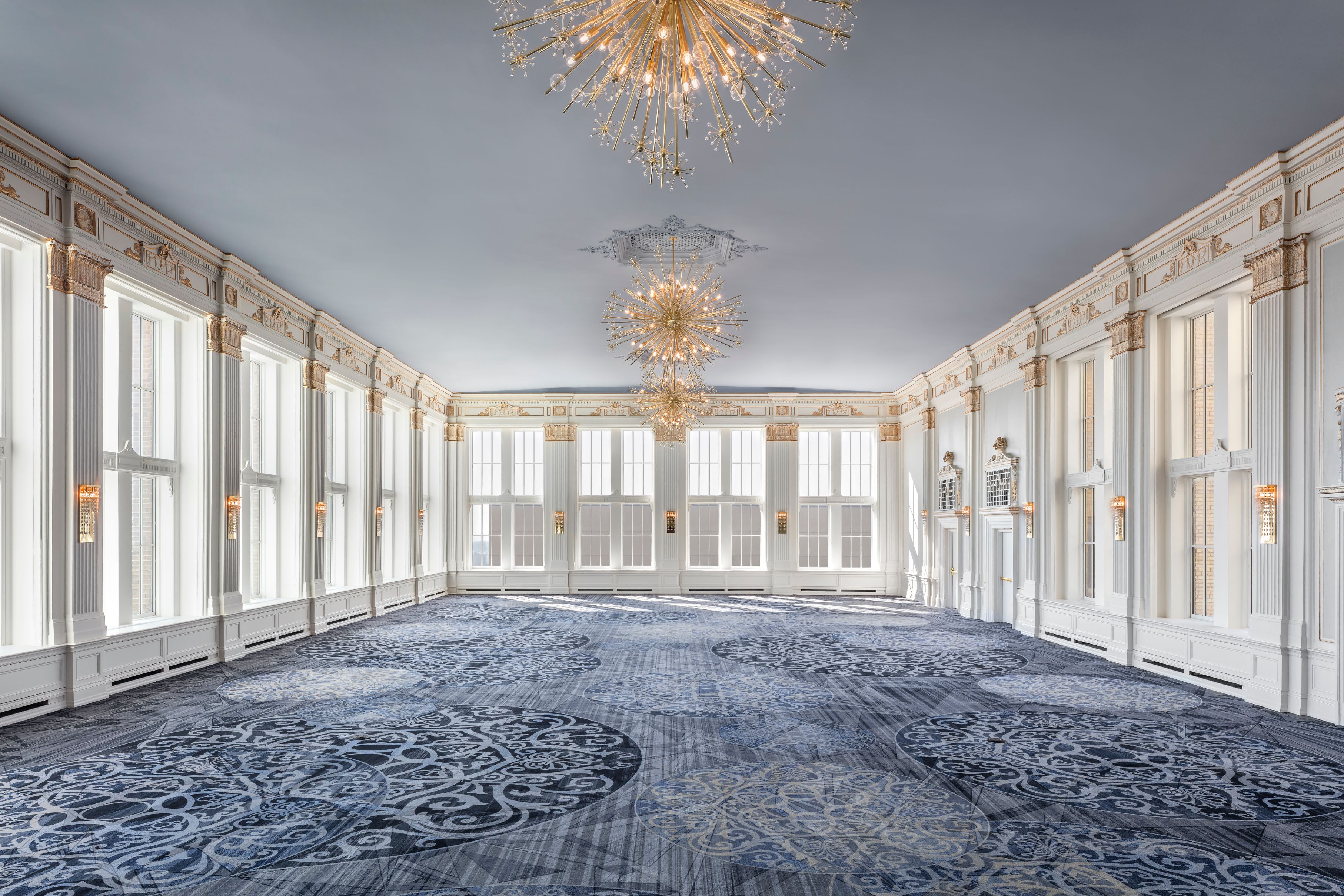 a large room with chandeliers and windows