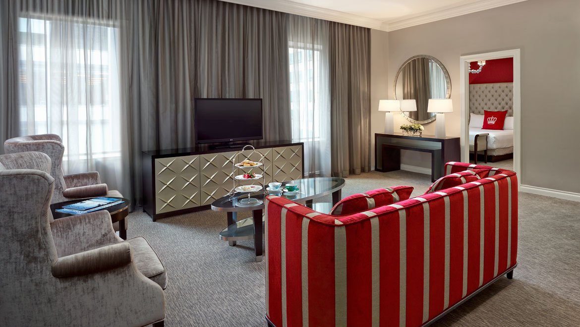 a living room with a red and white striped couch and a television