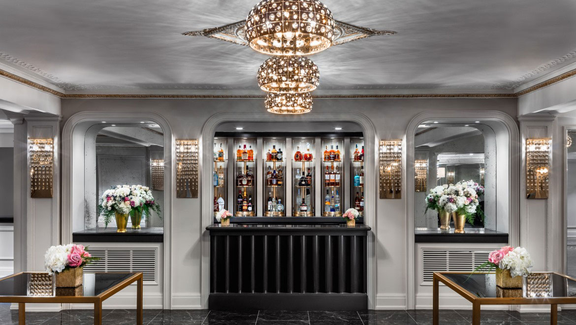 a bar with a chandelier and flowers