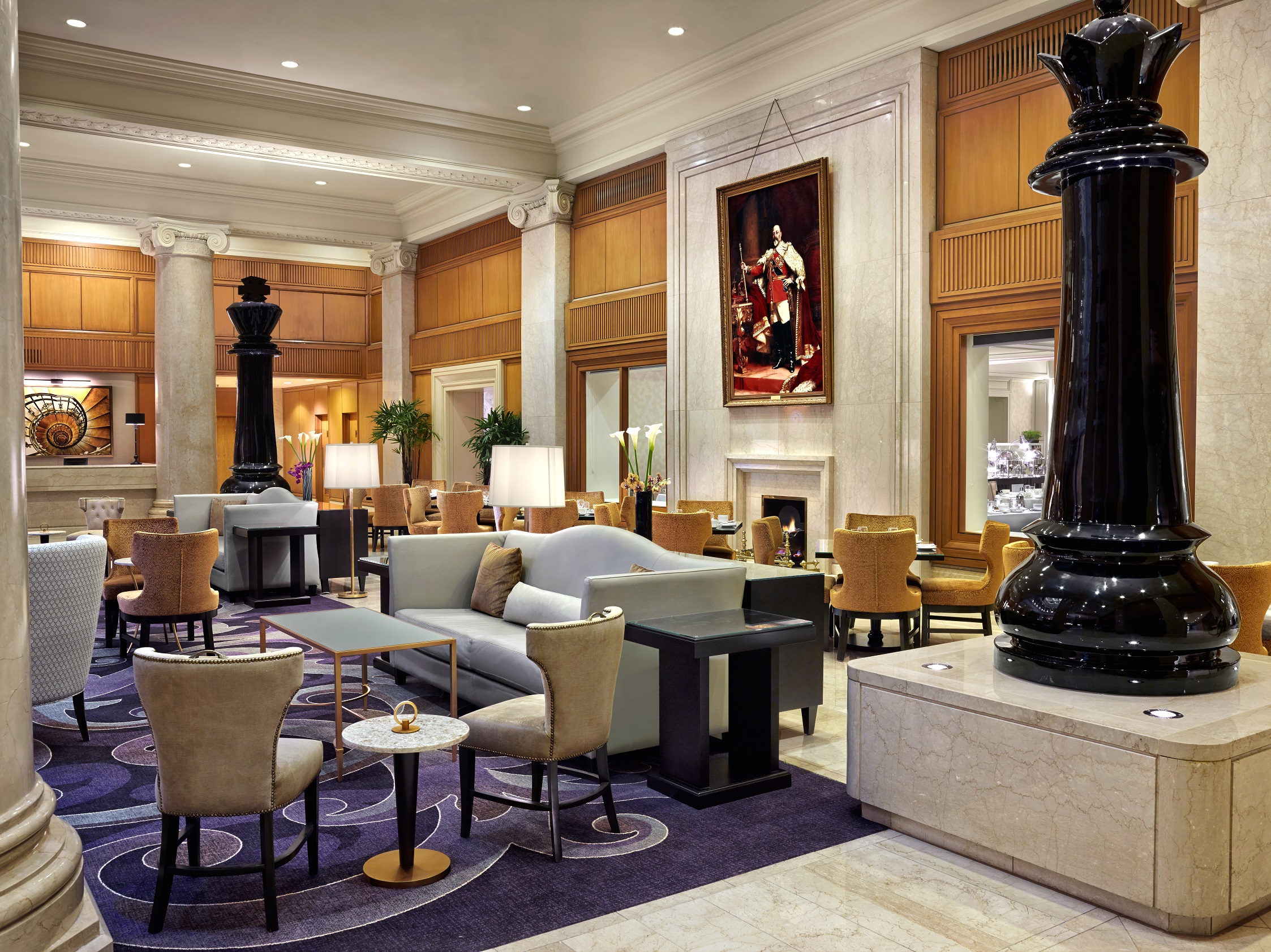 a room with a large black column and a large black statue