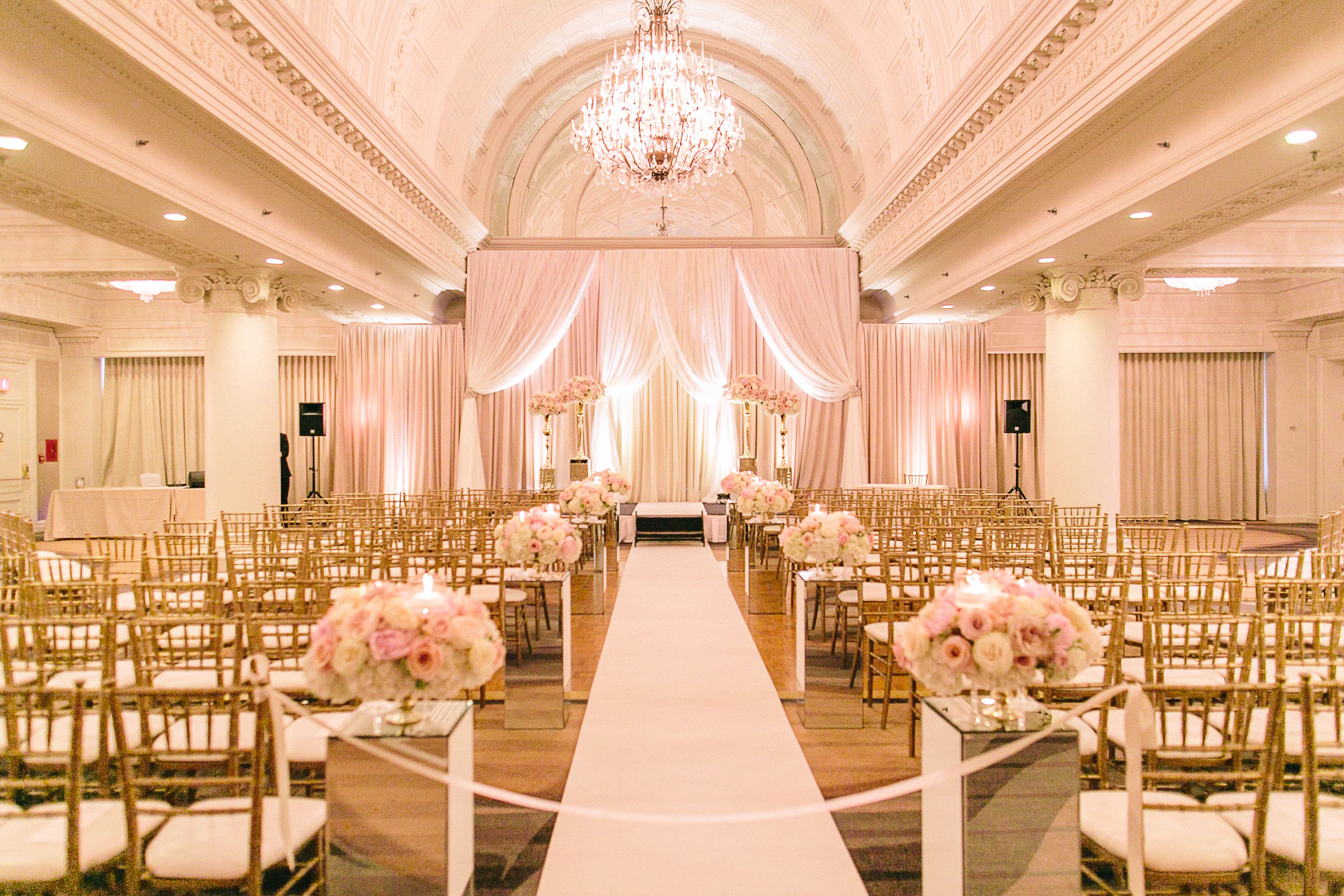 a wedding aisle with chairs and flowers