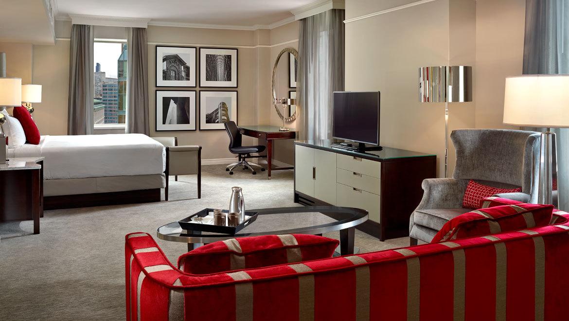 a room with a bed and a television