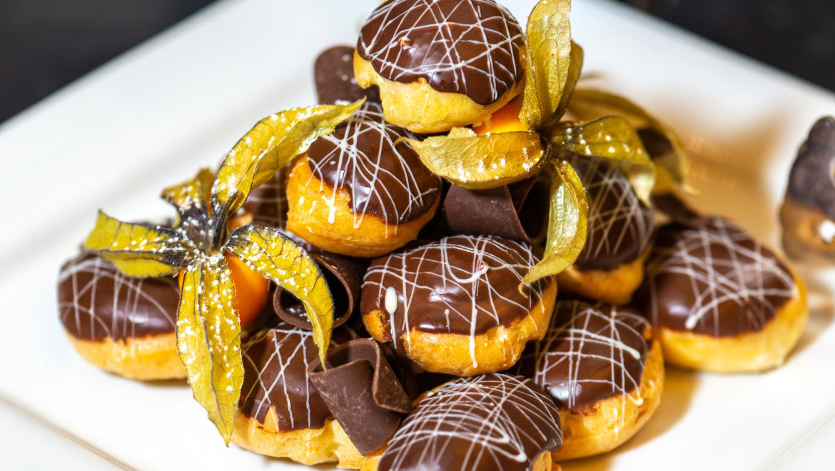 a plate of desserts with chocolate and dried flowers