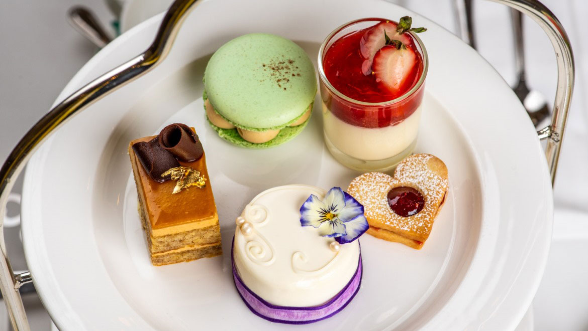 a plate of desserts and a cup of strawberry jelly