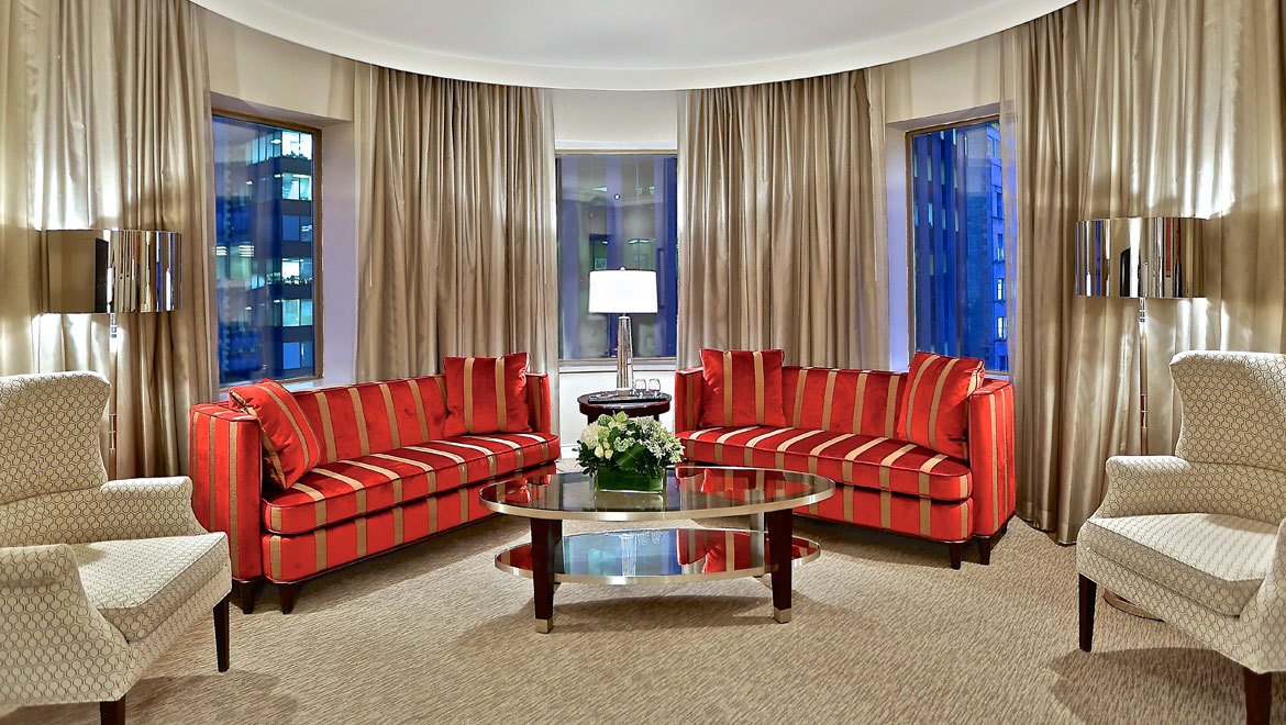 a room with red couches and a table