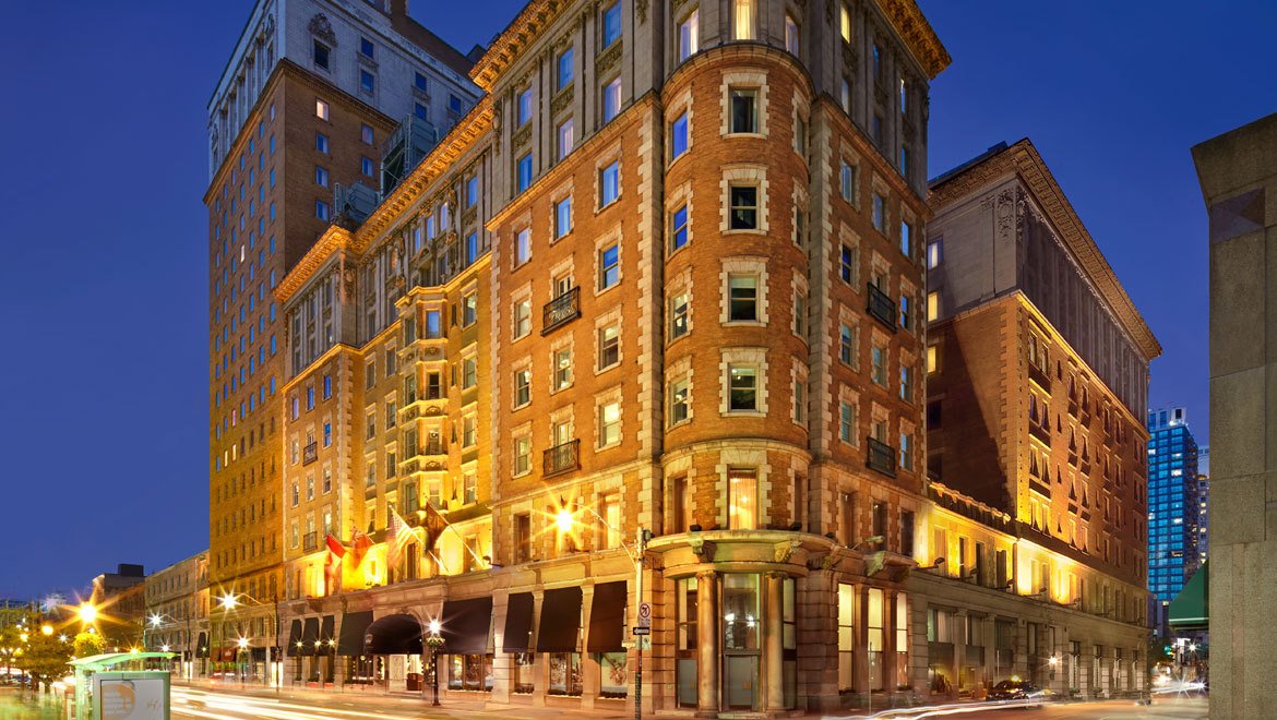 a building with many windows and a street in the background