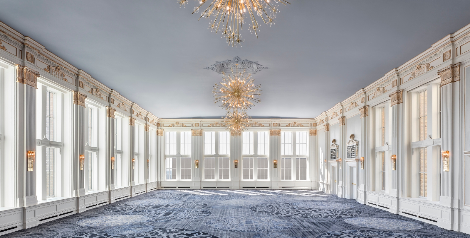 a large room with a chandelier and windows