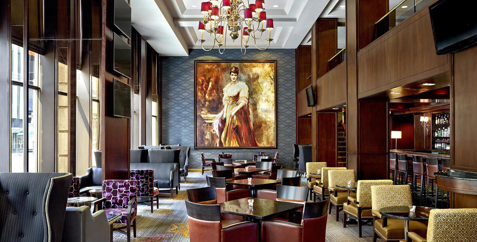 a room with a large painting of a woman