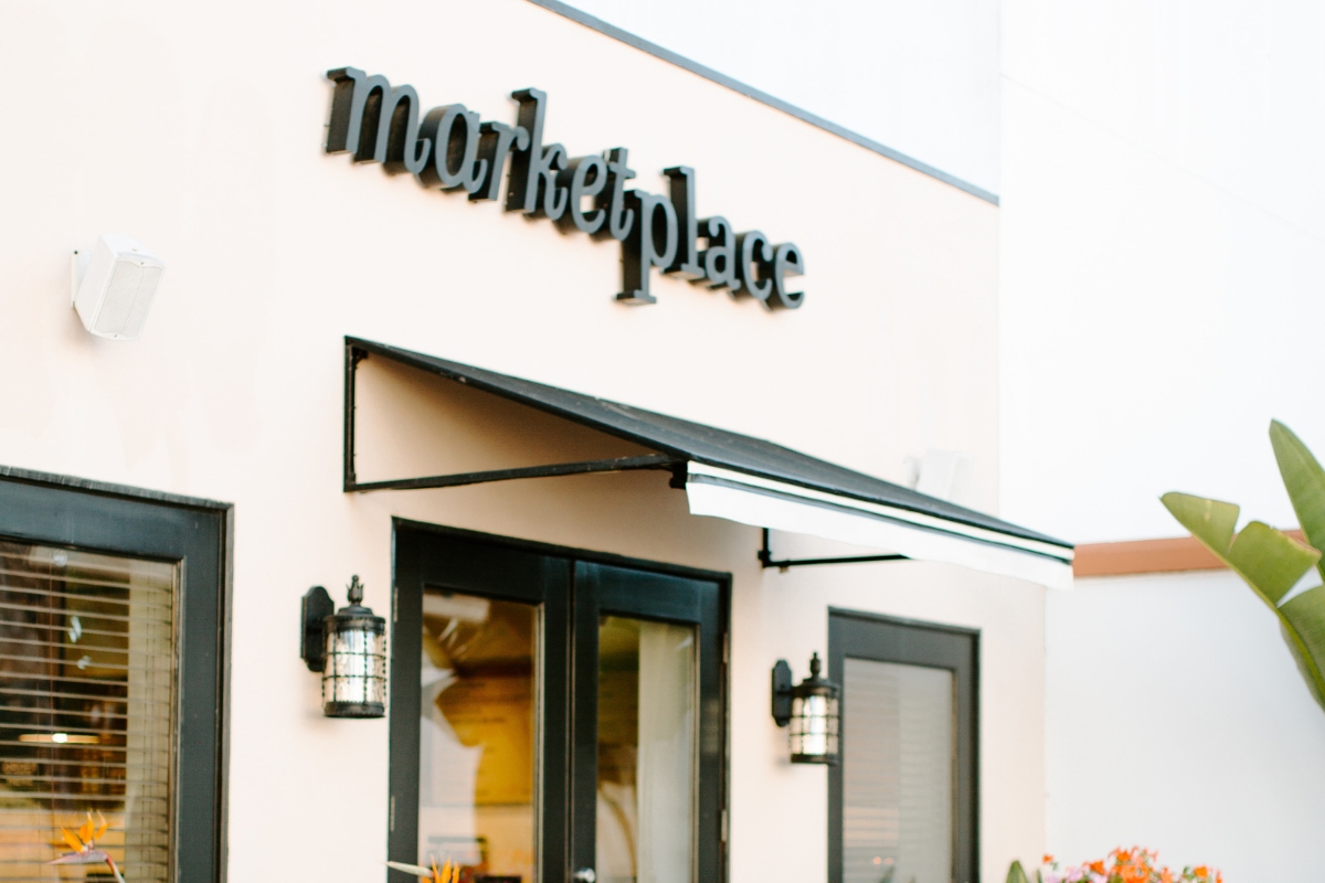 a store front with black sign