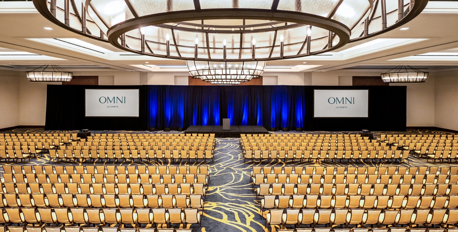 a room with a stage and chairs