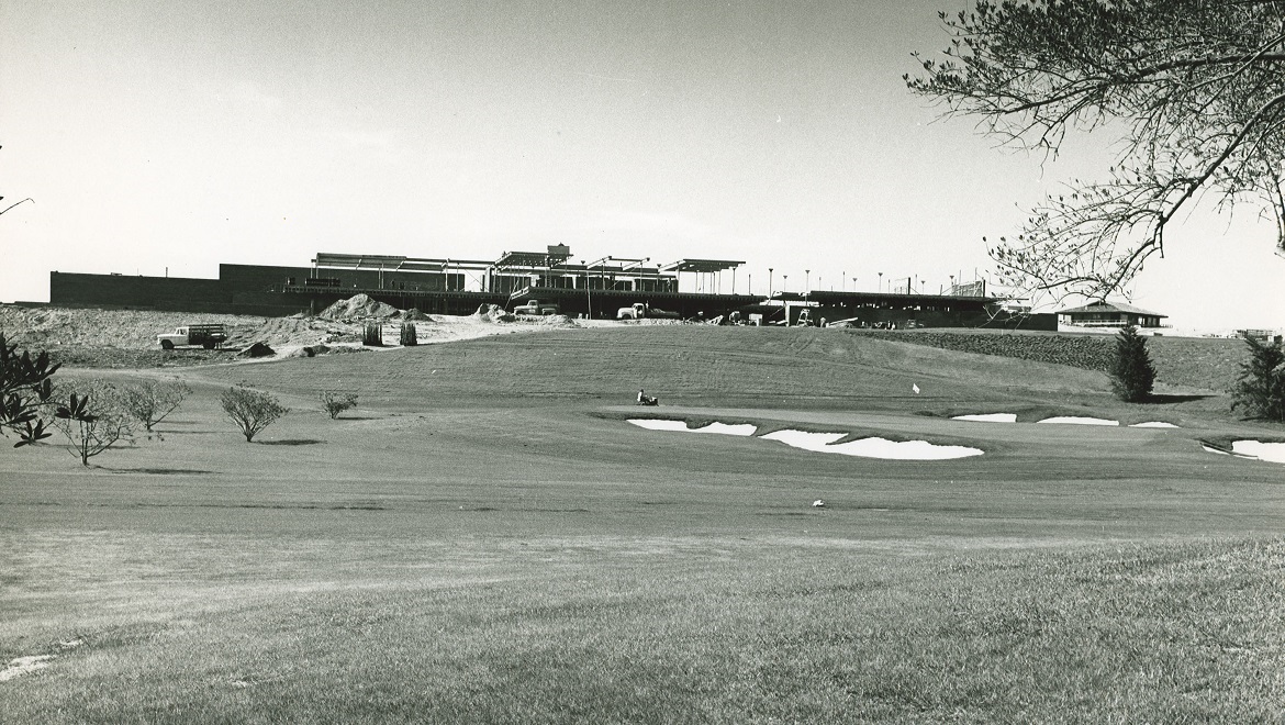 a golf course with a building in the background