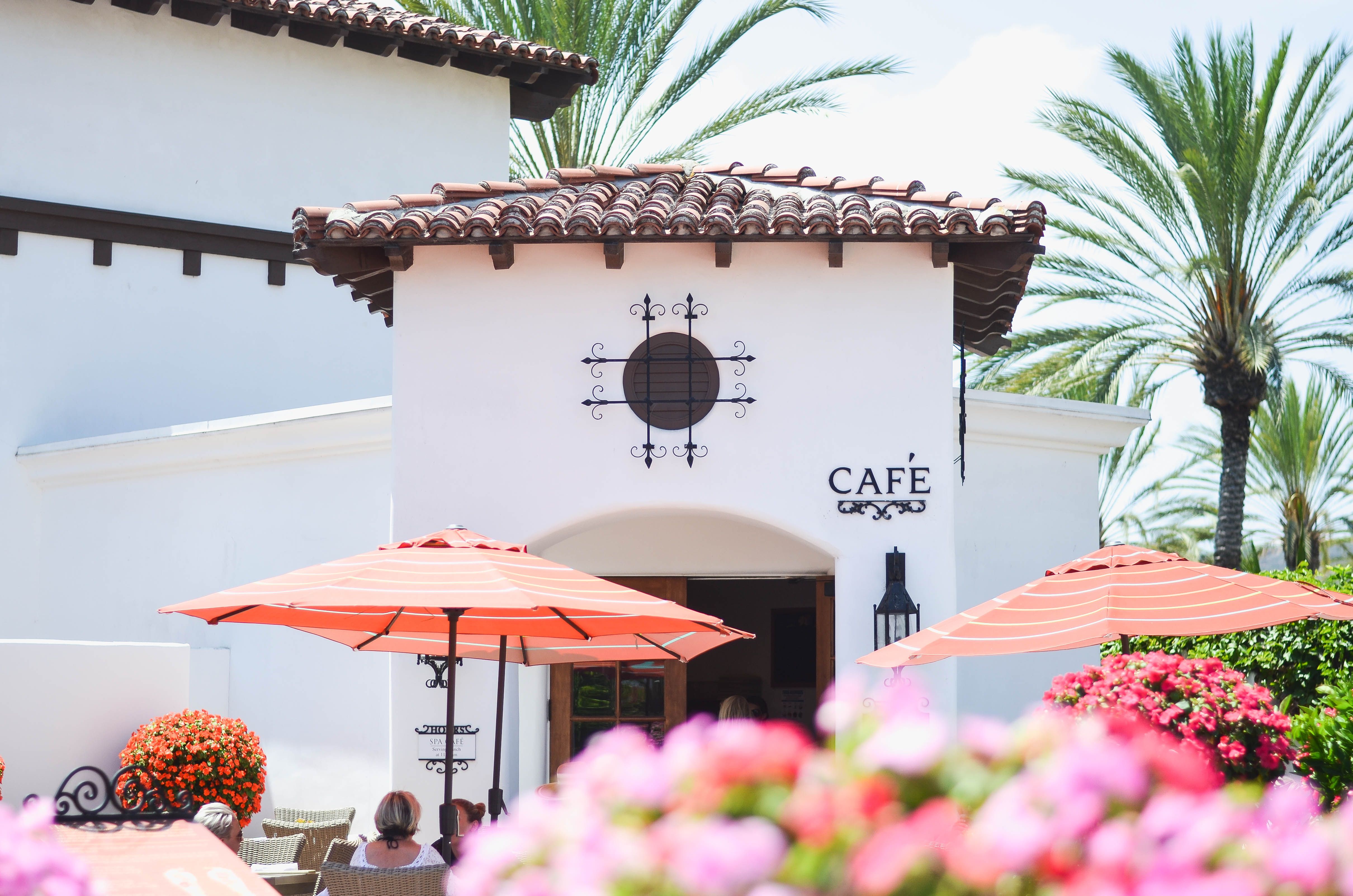 a building with a cafe and umbrellas