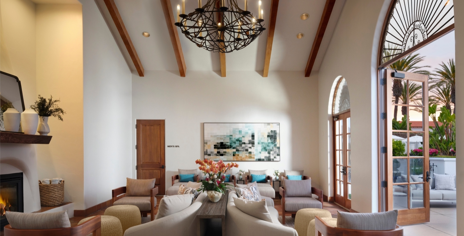a room with a chandelier and couches