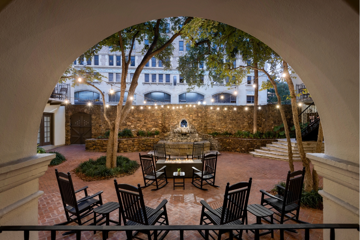 a courtyard with chairs and a table