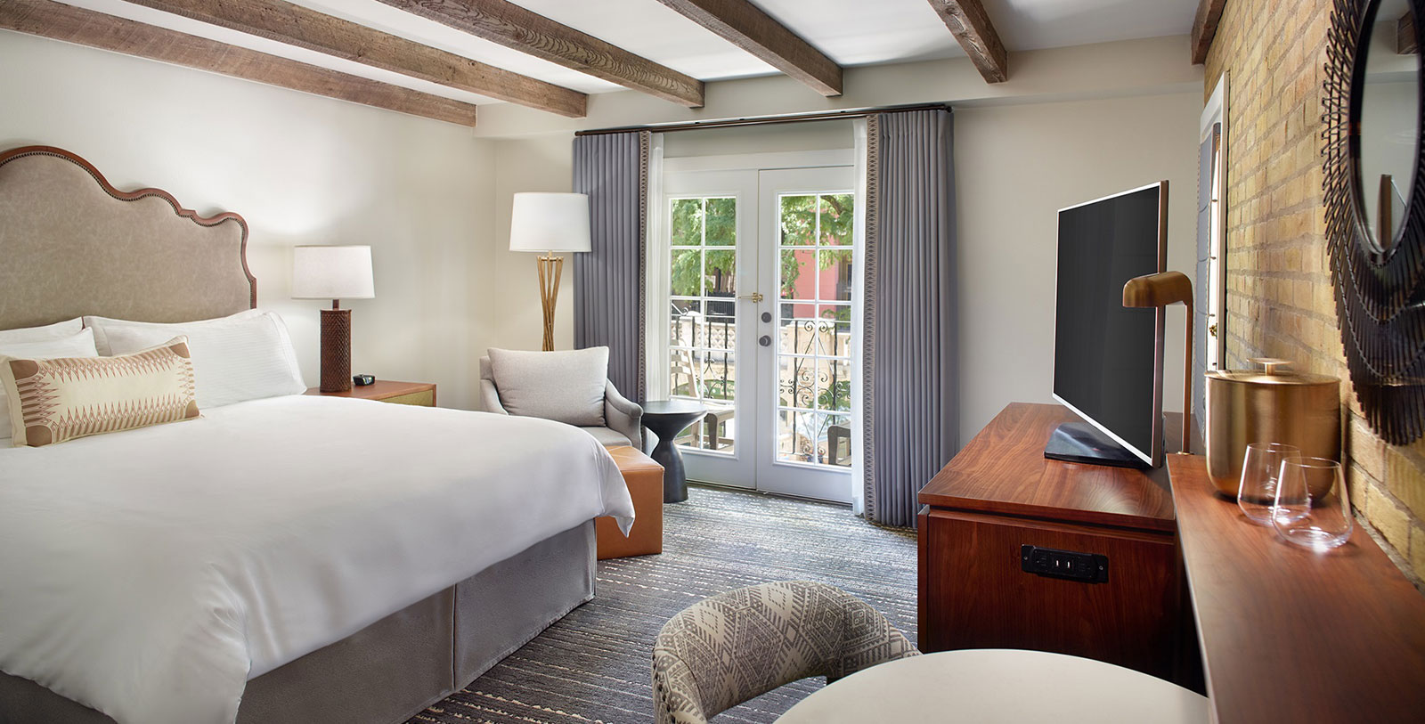 a room with a bed and a television