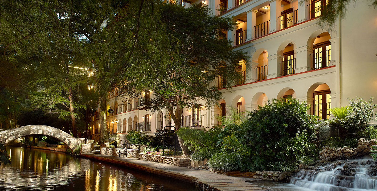 a building with trees and a river