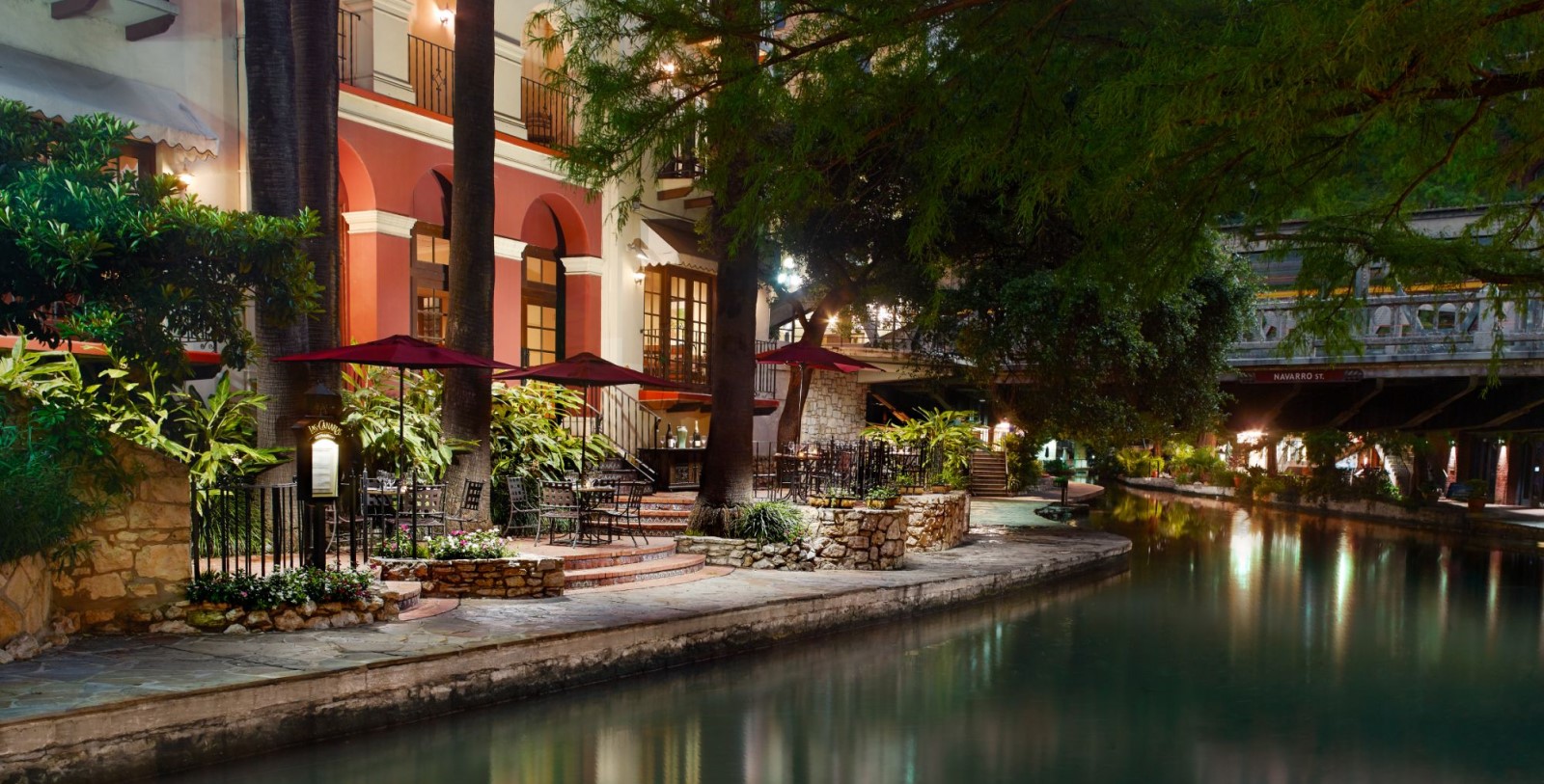 a building with trees and a river
