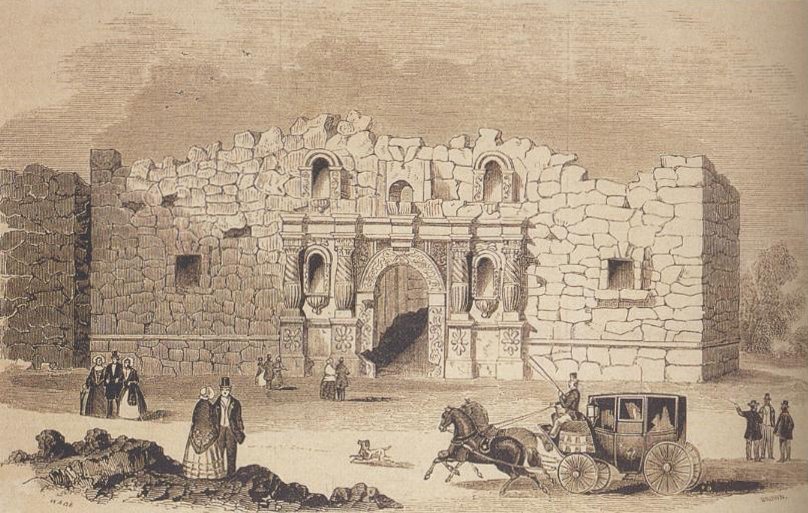 a horse drawn carriage in front of a stone wall