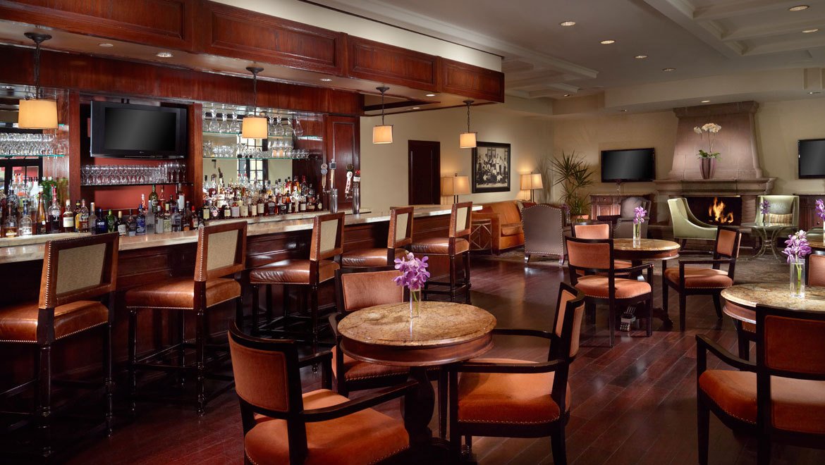 a room with a bar and chairs