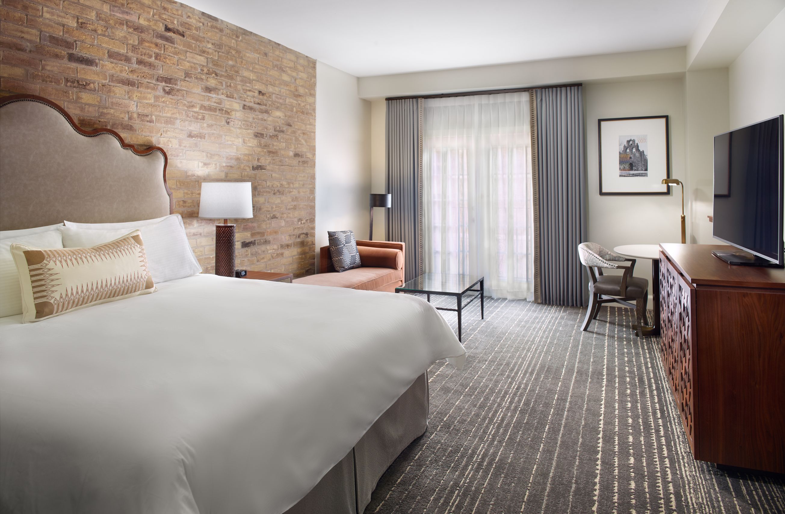 a room with a bed and a table and chairs