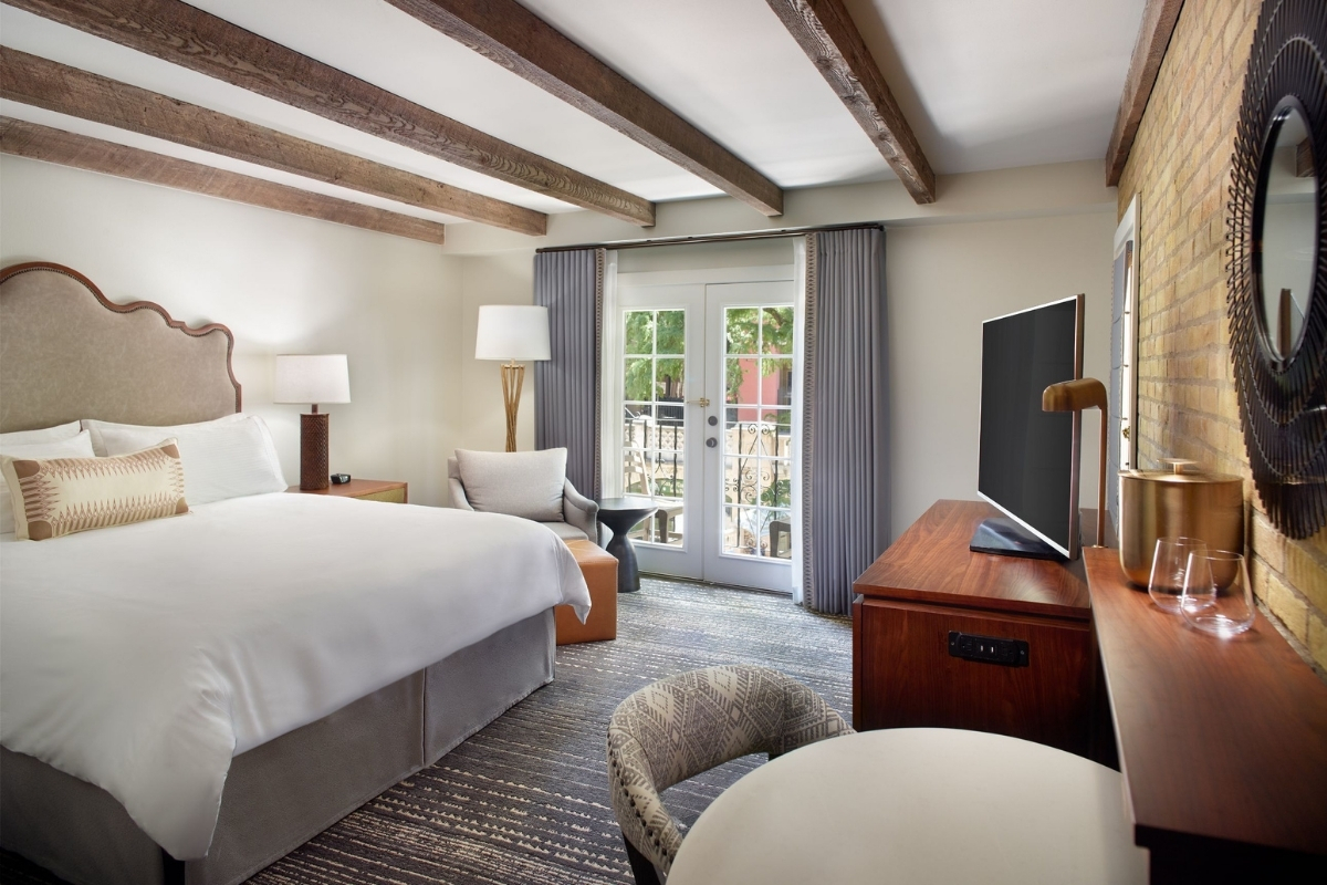 a room with a bed and a television