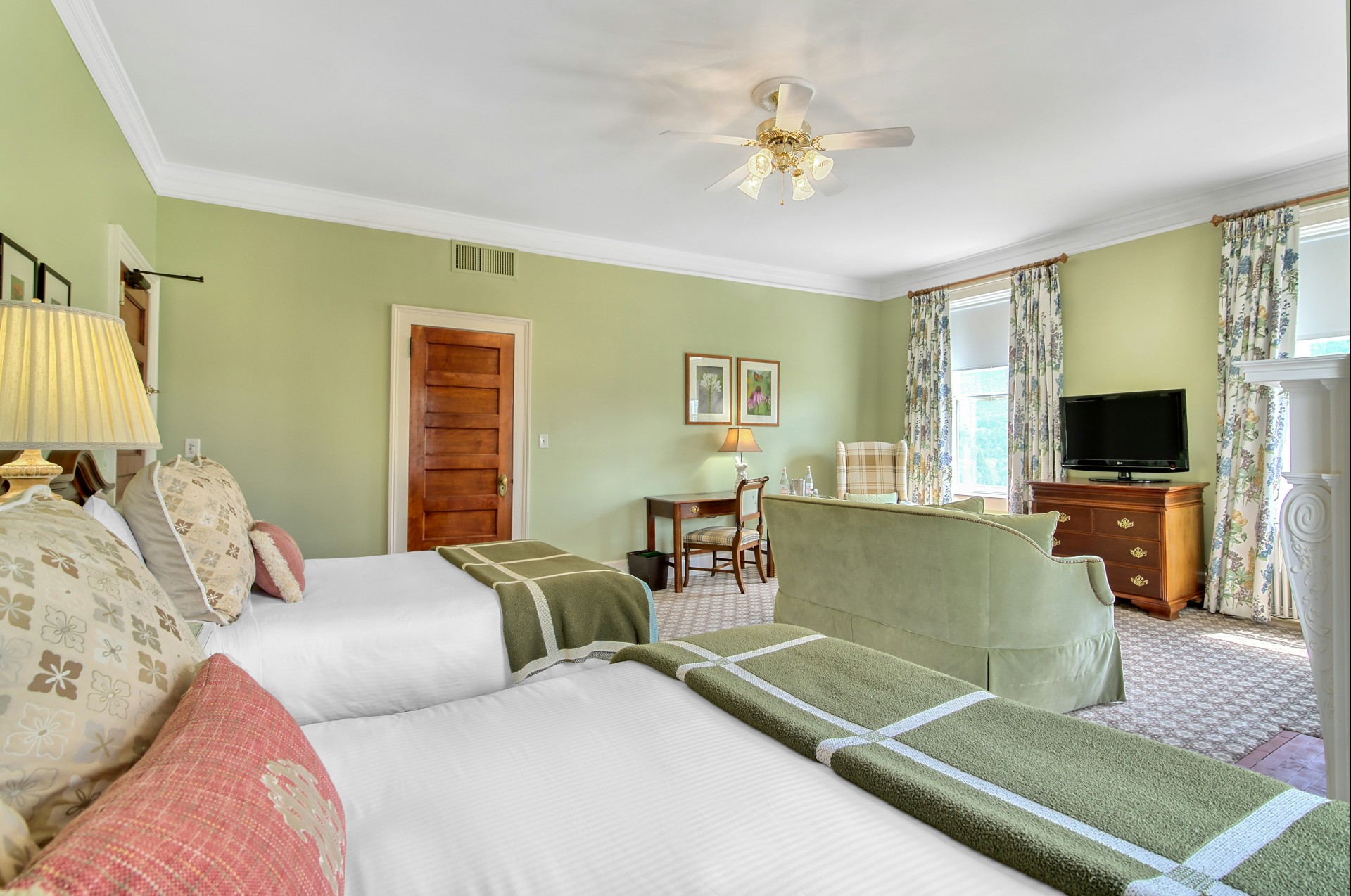 a room with two beds and a television